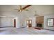 Comfortable living room featuring a brick fireplace, neutral carpet, ceiling fans, and natural light at 380 Hidden Valley Sw Dr, Conyers, GA 30094