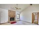 Bright living room featuring a brick fireplace, vaulted ceiling, ceiling fan, and hardwood trim at 380 Hidden Valley Sw Dr, Conyers, GA 30094
