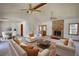 Bright living room features a brick fireplace, ceiling fan, and access to dining area at 380 Hidden Valley Sw Dr, Conyers, GA 30094