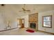 Inviting living room features a brick fireplace, neutral carpet, and a ceiling fan at 380 Hidden Valley Sw Dr, Conyers, GA 30094