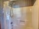 Clean white shower featuring a detachable shower head and neutral patterned wallpaper at 380 Hidden Valley Sw Dr, Conyers, GA 30094