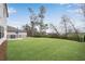 Large, well-maintained backyard with lush grass, an iron fence, and a patio area for outdoor entertaining at 708 Chipping Sparrow St, Canton, GA 30115