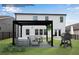 A cozy backyard patio area featuring a pergola, grill, and comfortable seating, perfect for outdoor relaxation at 708 Chipping Sparrow St, Canton, GA 30115