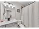 A clean and modern bathroom featuring a vanity with a single sink and a shower with a curtain at 708 Chipping Sparrow St, Canton, GA 30115