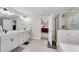 Bathroom featuring double sink vanity, tile floors, and a view into the bedroom at 708 Chipping Sparrow St, Canton, GA 30115