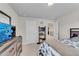 Bright bedroom featuring a TV, dresser, and ensuite door at 708 Chipping Sparrow St, Canton, GA 30115