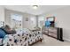 Bright bedroom with two windows and a TV on top of a dresser at 708 Chipping Sparrow St, Canton, GA 30115