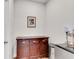 Butler pantry including dark wooden cabinetry, stainless steel mini-refrigerator and framed painting at 708 Chipping Sparrow St, Canton, GA 30115
