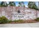 Welcoming brick entrance sign for Meadows at Idyllwilde with attractive landscaping at 708 Chipping Sparrow St, Canton, GA 30115
