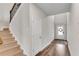 A bright entryway with hardwood floors, stairs, and a view of the front door with a wreath at 708 Chipping Sparrow St, Canton, GA 30115
