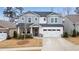 Charming two-story home with stone accents, a two-car garage, and a well-manicured lawn at 708 Chipping Sparrow St, Canton, GA 30115