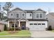 Charming two-story home featuring stone accents, a well-manicured lawn, and a two-car garage at 708 Chipping Sparrow St, Canton, GA 30115