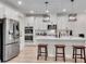 Bright kitchen features white cabinets, stainless steel appliances, and an island with seating at 708 Chipping Sparrow St, Canton, GA 30115