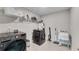Laundry room with gray washer and dryer, utility sink, and ample shelving at 708 Chipping Sparrow St, Canton, GA 30115