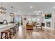 Spacious living room with a cozy fireplace, plush sofas, and access to a backyard patio at 708 Chipping Sparrow St, Canton, GA 30115