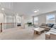 A well-lit living room with a comfortable sofa, a TV, and large windows offering scenic views at 708 Chipping Sparrow St, Canton, GA 30115