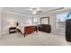 Bright main bedroom with a ceiling fan, tray ceiling, large windows, and neutral decor at 708 Chipping Sparrow St, Canton, GA 30115