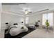 A serene main bedroom with soft carpet, a tray ceiling, and stylish furnishings at 708 Chipping Sparrow St, Canton, GA 30115