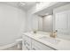 Bright bathroom featuring a double vanity with white countertops, tile flooring, and a large mirror at 104 Briargate Dr, Johns Creek, GA 30097