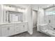 Elegant bathroom featuring double vanities, quartz countertops, and a frameless glass shower at 104 Briargate Dr, Johns Creek, GA 30097