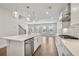 Bright kitchen with a central island, stainless steel dishwasher, and stylish pendant lights, perfect for entertaining at 104 Briargate Dr, Johns Creek, GA 30097
