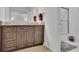 Bathroom vanity with granite countertops, wooden cabinets and neutral toned flooring at 1363 Sheffield Glen Way, Atlanta, GA 30329