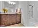 Updated bathroom features granite counters, warm-toned cabinets, and tiled shower with glass door at 1363 Sheffield Glen Way, Atlanta, GA 30329