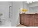 Cozy bathroom features a classic white toilet and vanity with a neutral countertop, and a glass shower door at 1363 Sheffield Glen Way, Atlanta, GA 30329