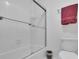 Updated bathroom boasts a tiled shower with sliding glass doors and a modern toilet at 1363 Sheffield Glen Way, Atlanta, GA 30329