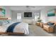 Bright, virtually staged bedroom with wicker accents, coastal art, and lots of natural light, creating a serene space at 1363 Sheffield Glen Way, Atlanta, GA 30329