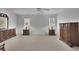 Spacious bedroom with neutral carpet, two windows, and two dressers providing ample storage and organization at 1363 Sheffield Glen Way, Atlanta, GA 30329