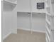 Walk-in closet with white shelving and hanging racks offers ample storage space and a built-in safe at 1363 Sheffield Glen Way, Atlanta, GA 30329