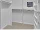 An organized walk-in closet featuring custom shelving and a built-in safe for secure storage at 1363 Sheffield Glen Way, Atlanta, GA 30329