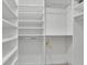 Walk-in closet featuring custom built-in shelving, rods and white finish at 1363 Sheffield Glen Way, Atlanta, GA 30329