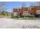 Charming townhouse with brick facade, bay windows, and landscaped front yard on a sunny day at 1363 Sheffield Glen Way, Atlanta, GA 30329