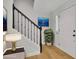 Bright foyer with hardwood floors, black staircase, and white door leading to living space at 1363 Sheffield Glen Way, Atlanta, GA 30329