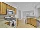 Bright kitchen featuring stainless steel appliances, stone countertops and light wood cabinets at 1363 Sheffield Glen Way, Atlanta, GA 30329