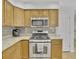 Bright kitchen featuring stainless steel appliances, stone countertops and light wood cabinets at 1363 Sheffield Glen Way, Atlanta, GA 30329