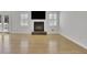 Living area features a fireplace, television, and bright natural light from large windows at 1363 Sheffield Glen Way, Atlanta, GA 30329