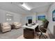 Bright office with a large desk, comfortable seating, and ample natural light. Virtually Staged at 1363 Sheffield Glen Way, Atlanta, GA 30329
