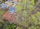 Aerial shot of the property featuring a deck and a spacious tree-lined backyard ideal for outdoor enjoyment at 1752 Atherton Dr, Decatur, GA 30035