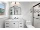 Modern bathroom featuring marble countertop, sleek black faucet, and tiled walk-in shower at 1752 Atherton Dr, Decatur, GA 30035