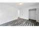 Spacious bedroom featuring new floors, white walls, closet and a doorway leading to other rooms at 1752 Atherton Dr, Decatur, GA 30035