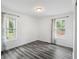 Bright bedroom with hardwood floors, fresh white paint, and natural light from two large windows at 1752 Atherton Dr, Decatur, GA 30035