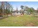 Spacious yard showcasing a charming one-story home with stone accents and a quaint porch at 1752 Atherton Dr, Decatur, GA 30035