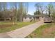 Cozy house with a lengthy driveway, stone accents, a lush lawn, and a newly planted tree at 1752 Atherton Dr, Decatur, GA 30035