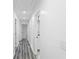 Hallway with newly painted white walls and grey wood flooring at 1752 Atherton Dr, Decatur, GA 30035