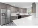 Modern kitchen with gray cabinets, quartz countertops and stainless steel refrigerator at 1752 Atherton Dr, Decatur, GA 30035