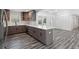 Open kitchen with quartz countertops, new appliances, and gray wood flooring at 1752 Atherton Dr, Decatur, GA 30035