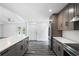 Bright kitchen featuring gray cabinets, stainless steel appliances, and gray wood flooring at 1752 Atherton Dr, Decatur, GA 30035